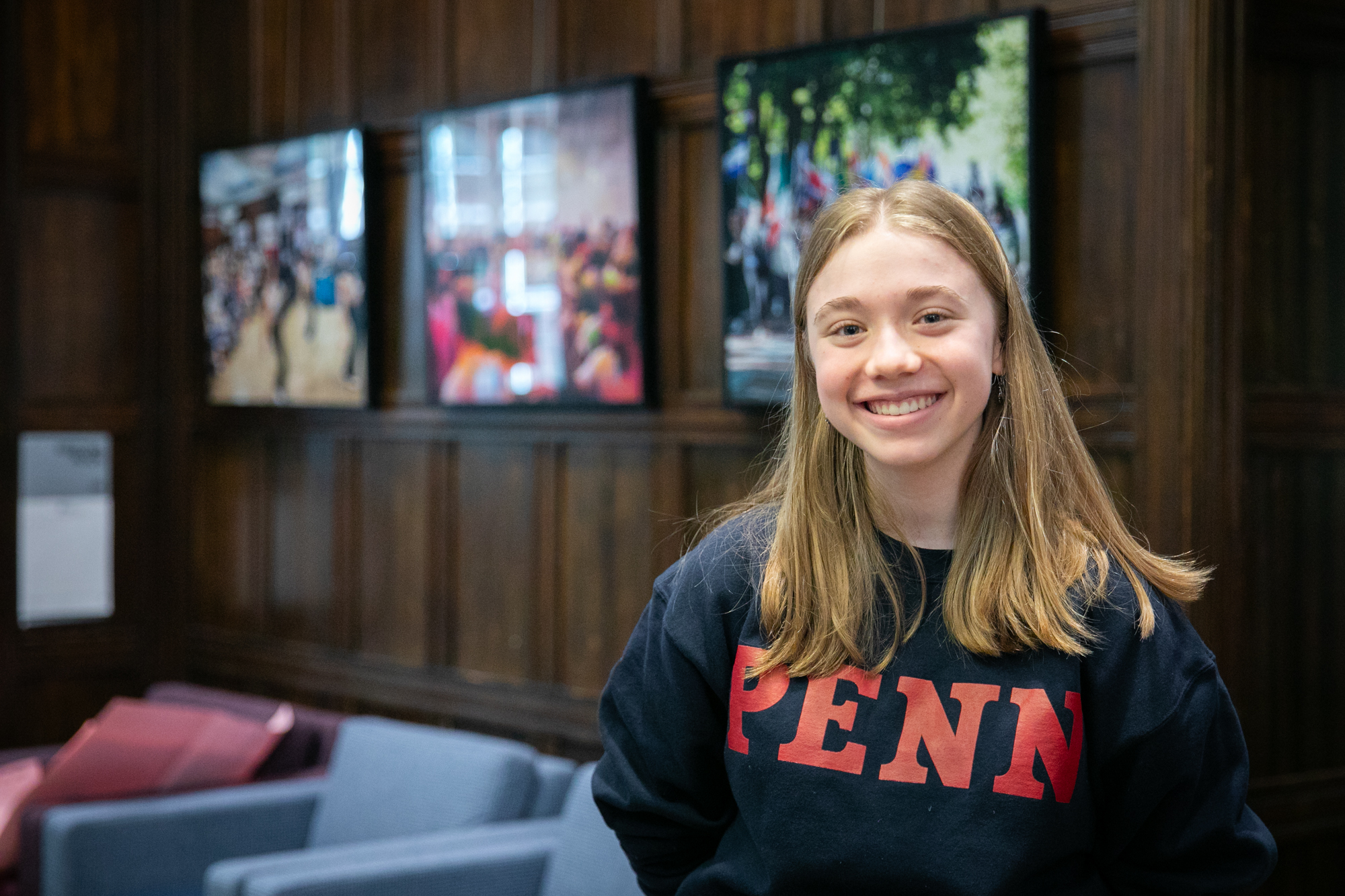 Sophmore Jane Kinney smiles inside a sitting room at The ARCH building on Penn's campus.