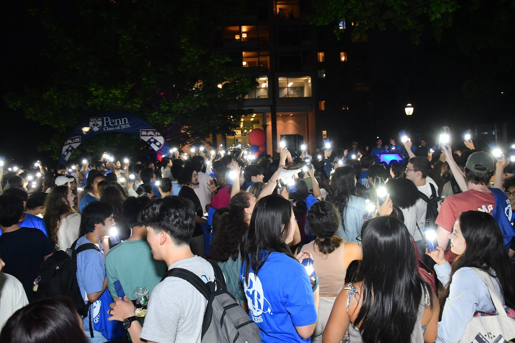 A crowd of second-year students hold up their lanterns on U-Night.