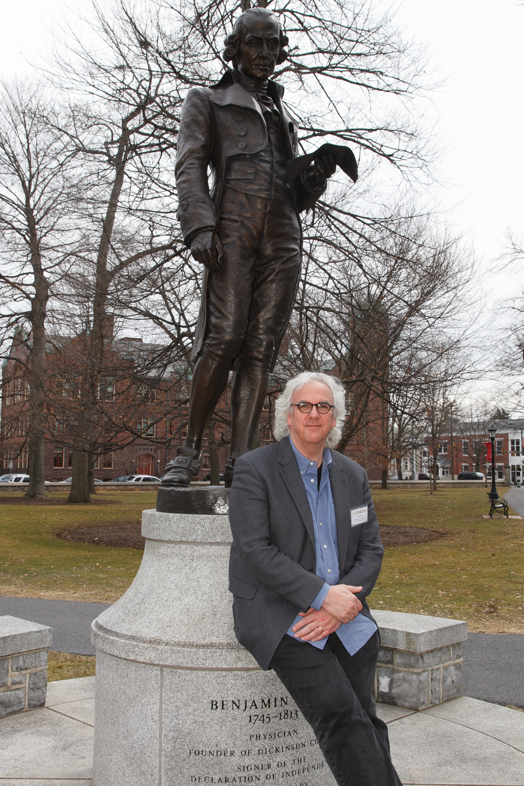 Stephen Rush next to statue