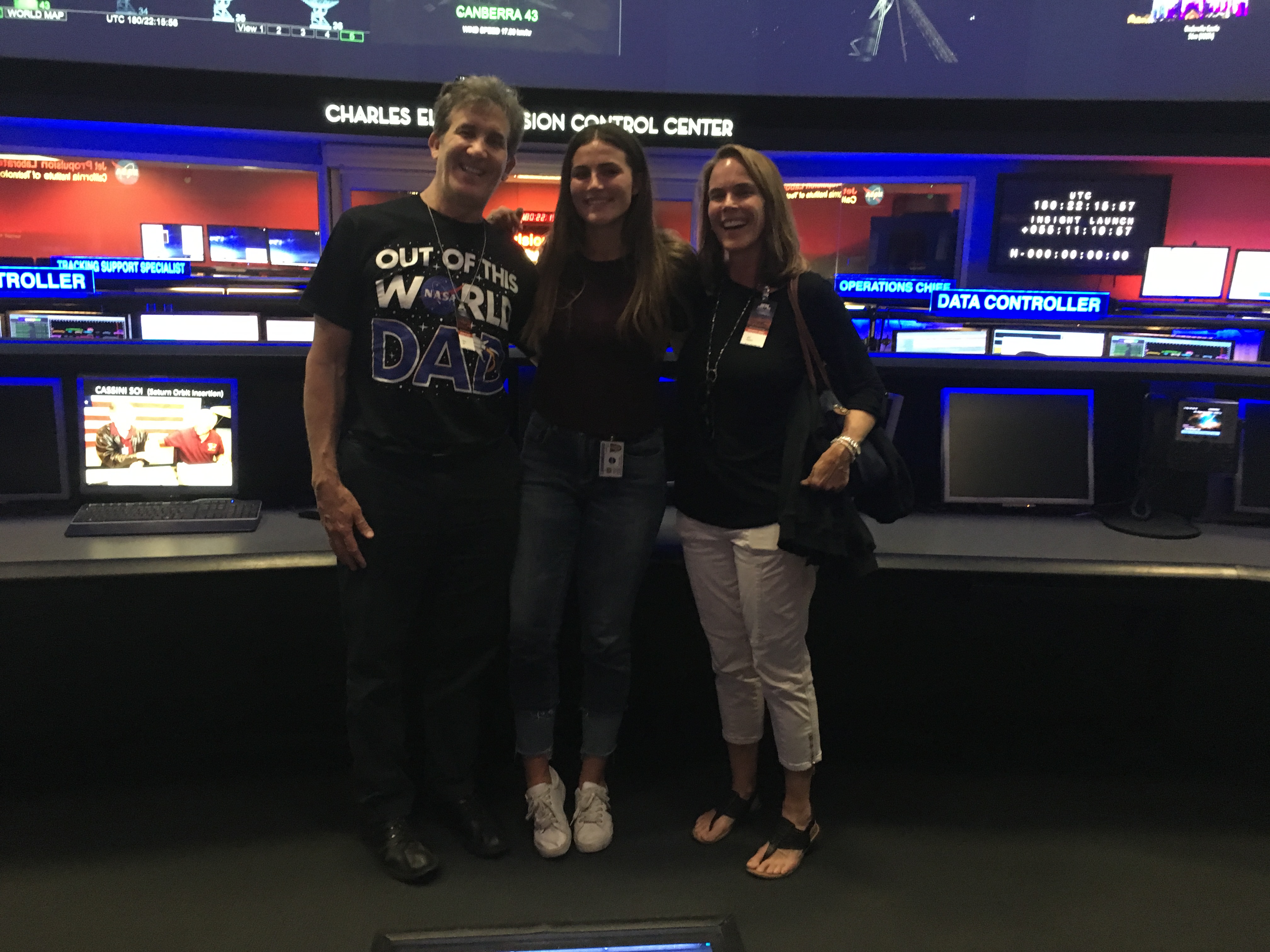 ulin posing with her parents in the control room