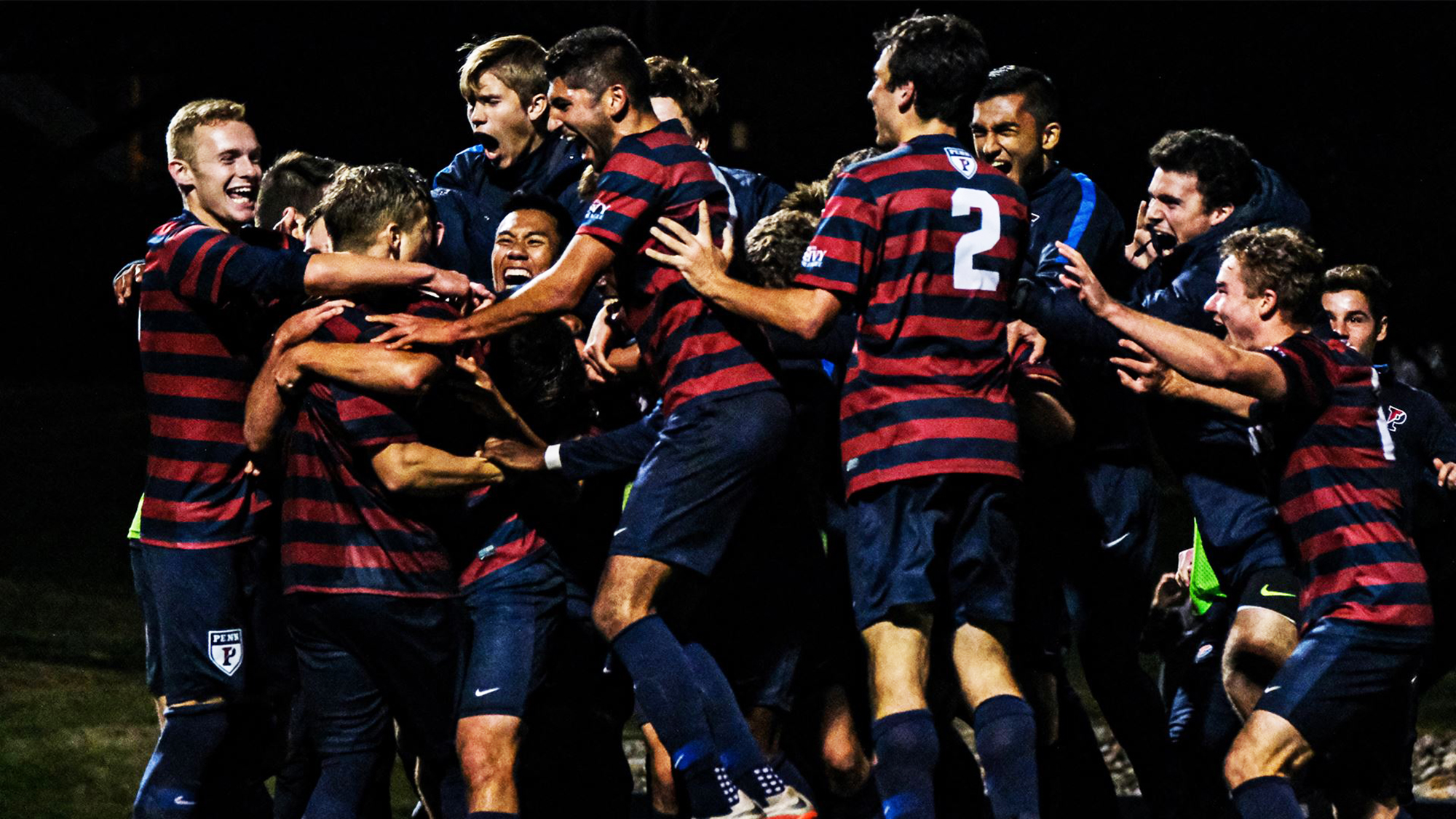 Members of the men's soccer team celebrate after the game-winning goal against Yale.
