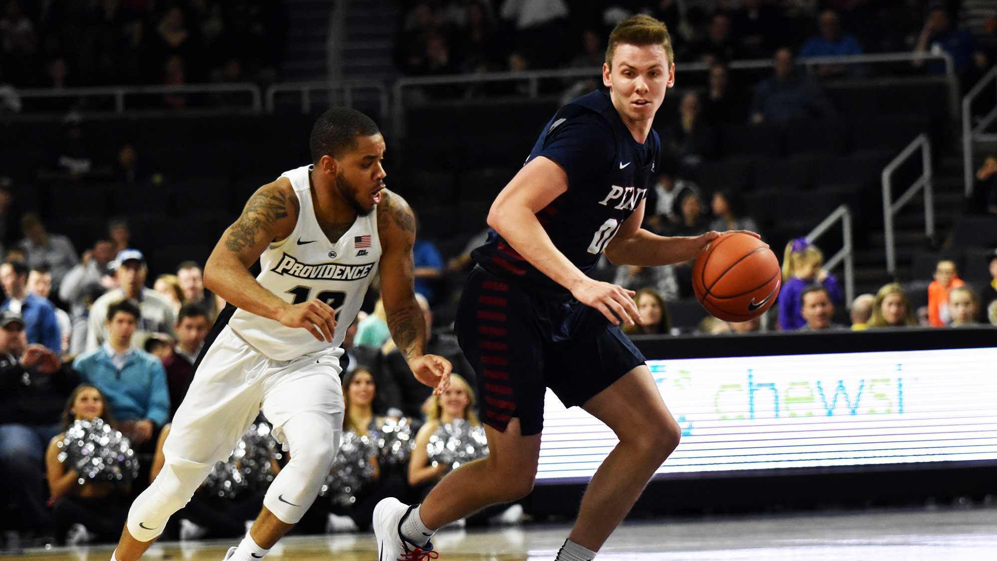 Ryan Betley dribbles with the ball while being guarded by a defender at Providence.