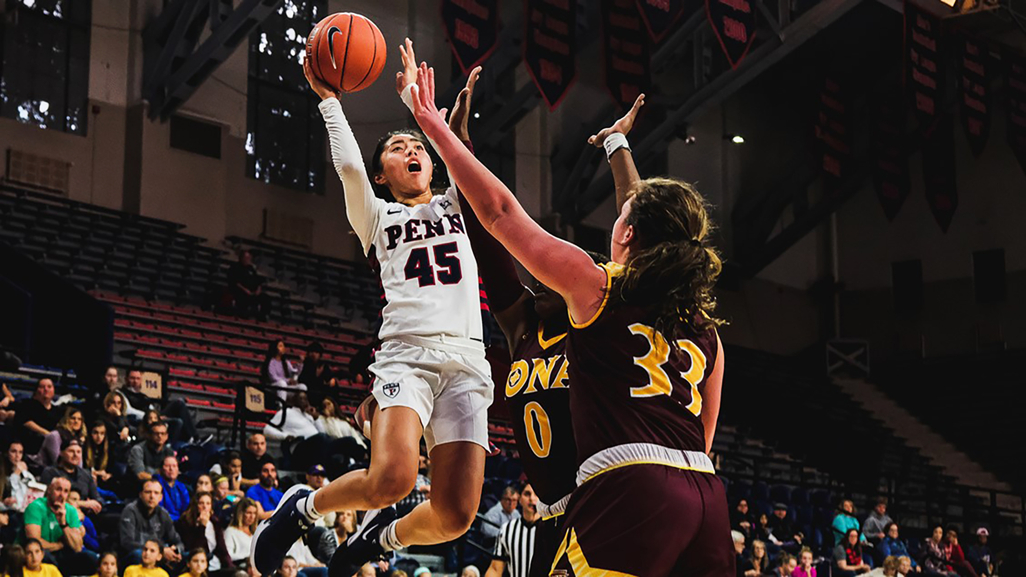 Freshman Kayla Padilla shots the ball between two defenders against Iona at the Palestra.