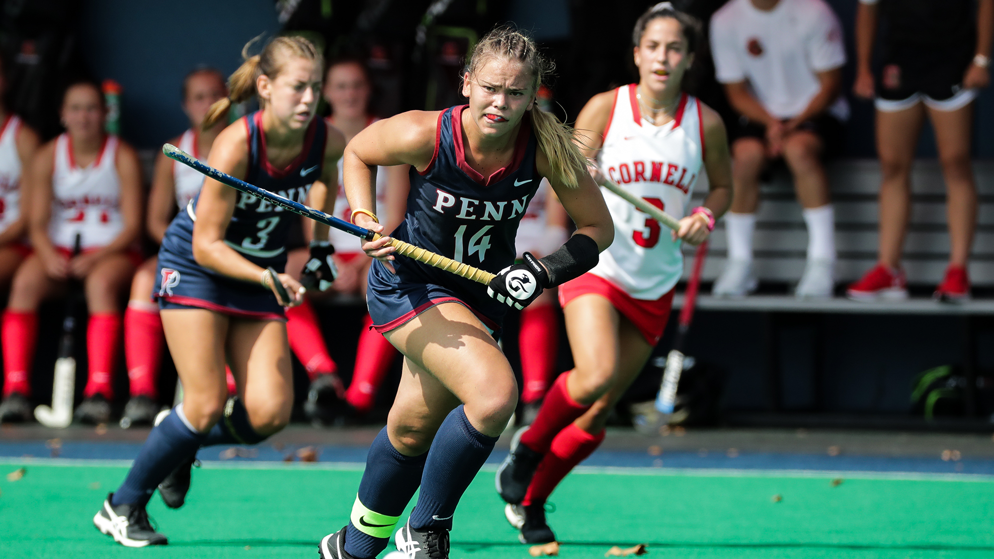 During a game against Cornell, Alexa Schneck runs down the field with her stick in her hand.