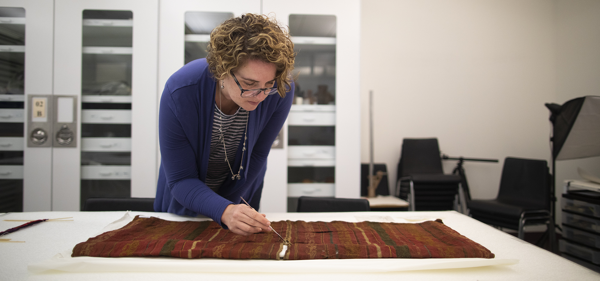 Anne Tiballi analyzing textiles