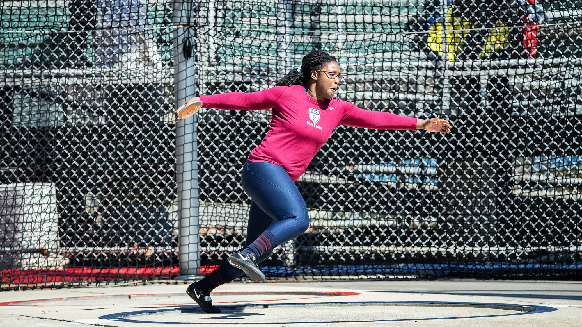 Sophomore thrower Mayyi Mahama prepares to throw the discus from the throwing circle during an event.
