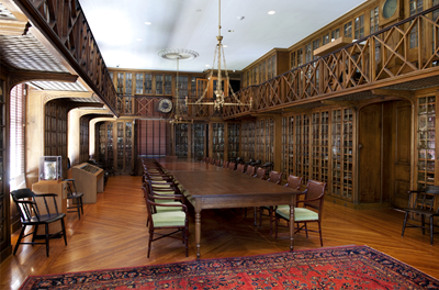 an ornate library with wooden shelves covering the walls