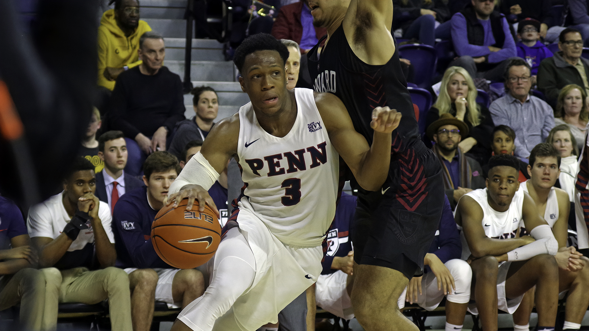 Jordan Dingle of the men's basketball team drives to the basket with the ball at the Palestra versus Harvard.