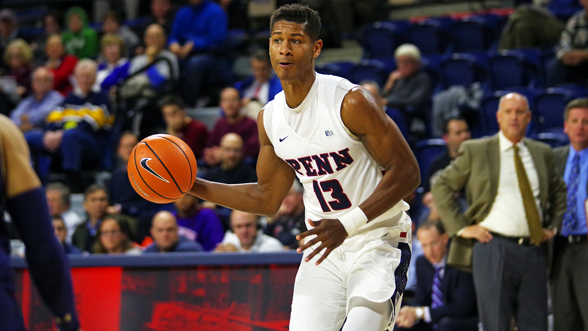 Junior guard Eddie Scott dribbles up the court at the Palestra.