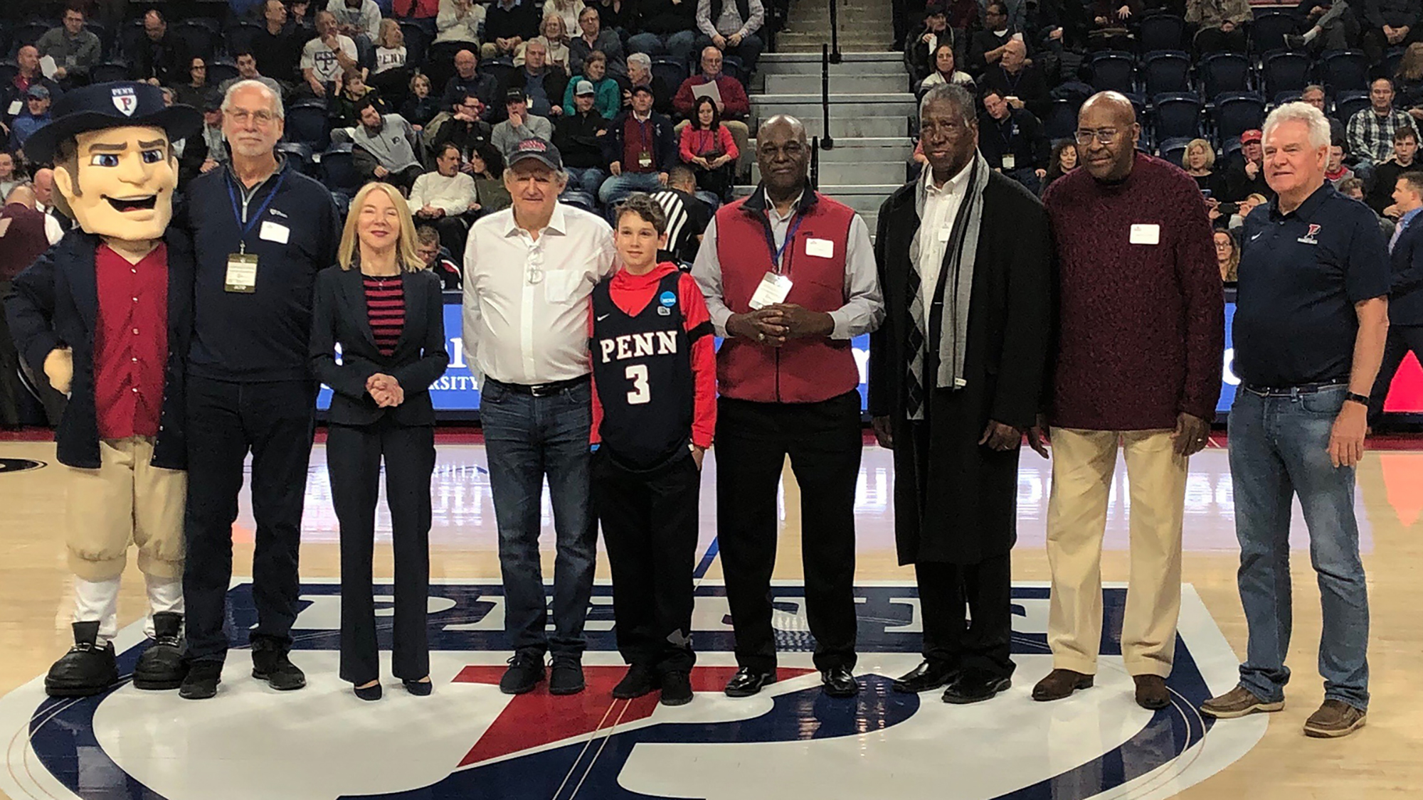 Penn President Amy Gutmann, third from left, honors Penn basketball alumni during halftime of the Dartmouth game.