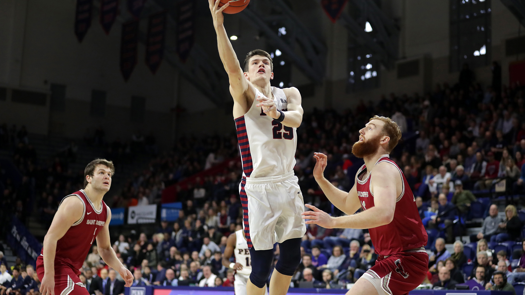 AJ Brodeur shoots a basket on court during a game