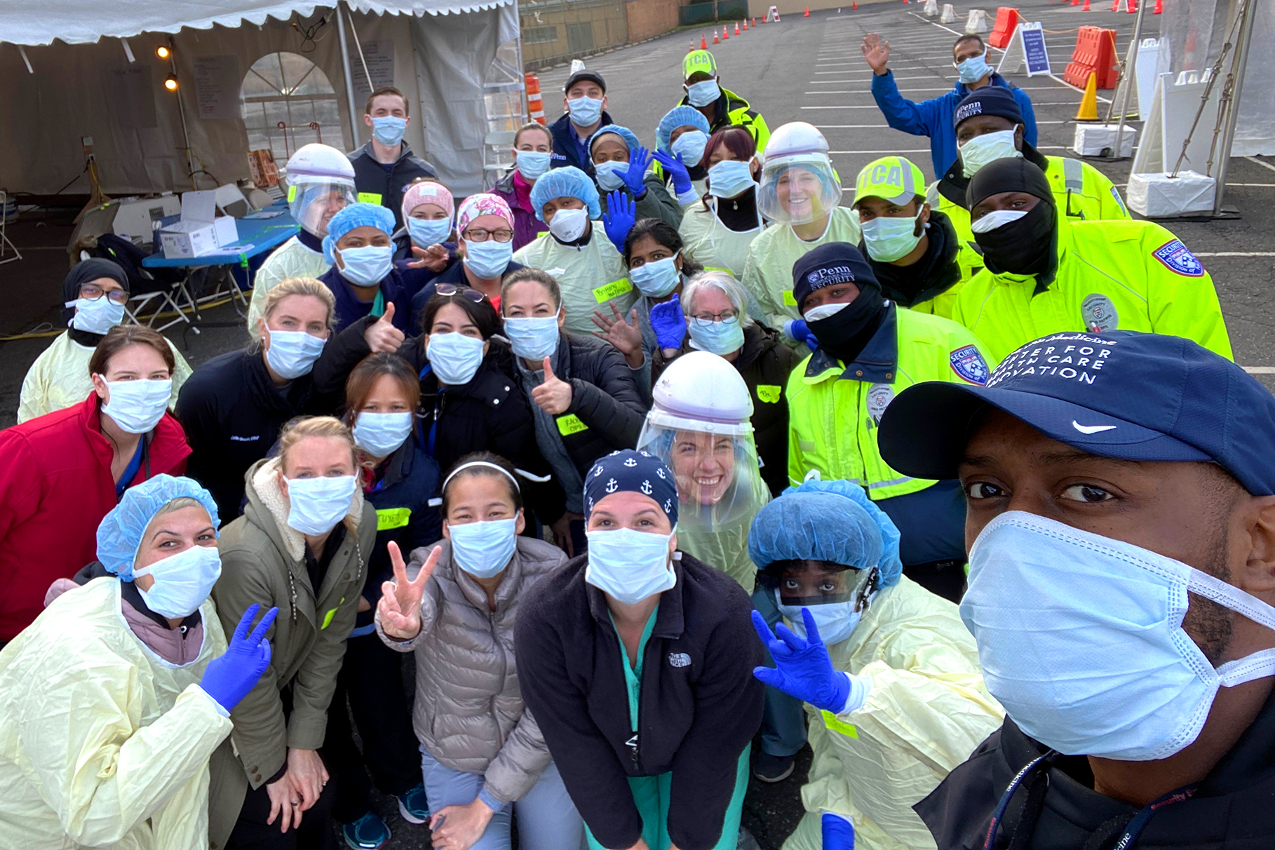 penn med staffers with ppe in parking lot