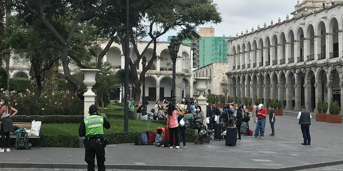 People with luggage in the central plaza in Arequipa Peru. 