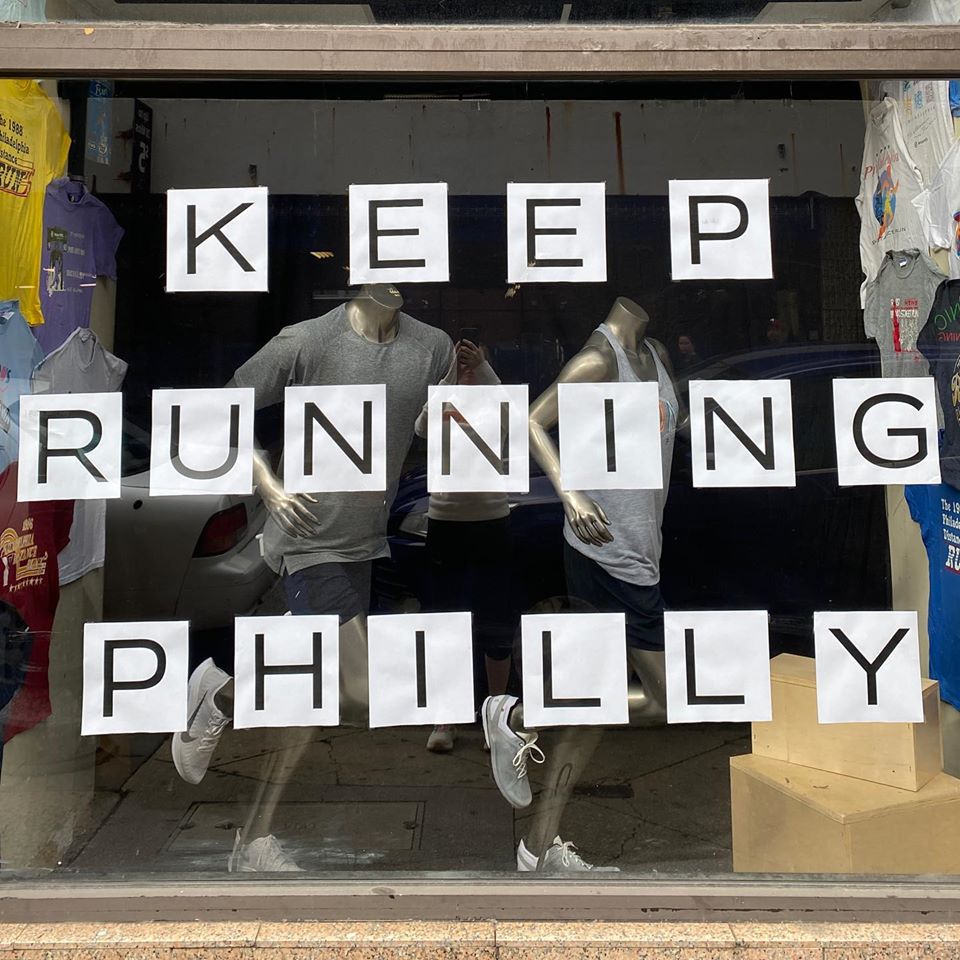 storefront sign saying "keep Running Philly"