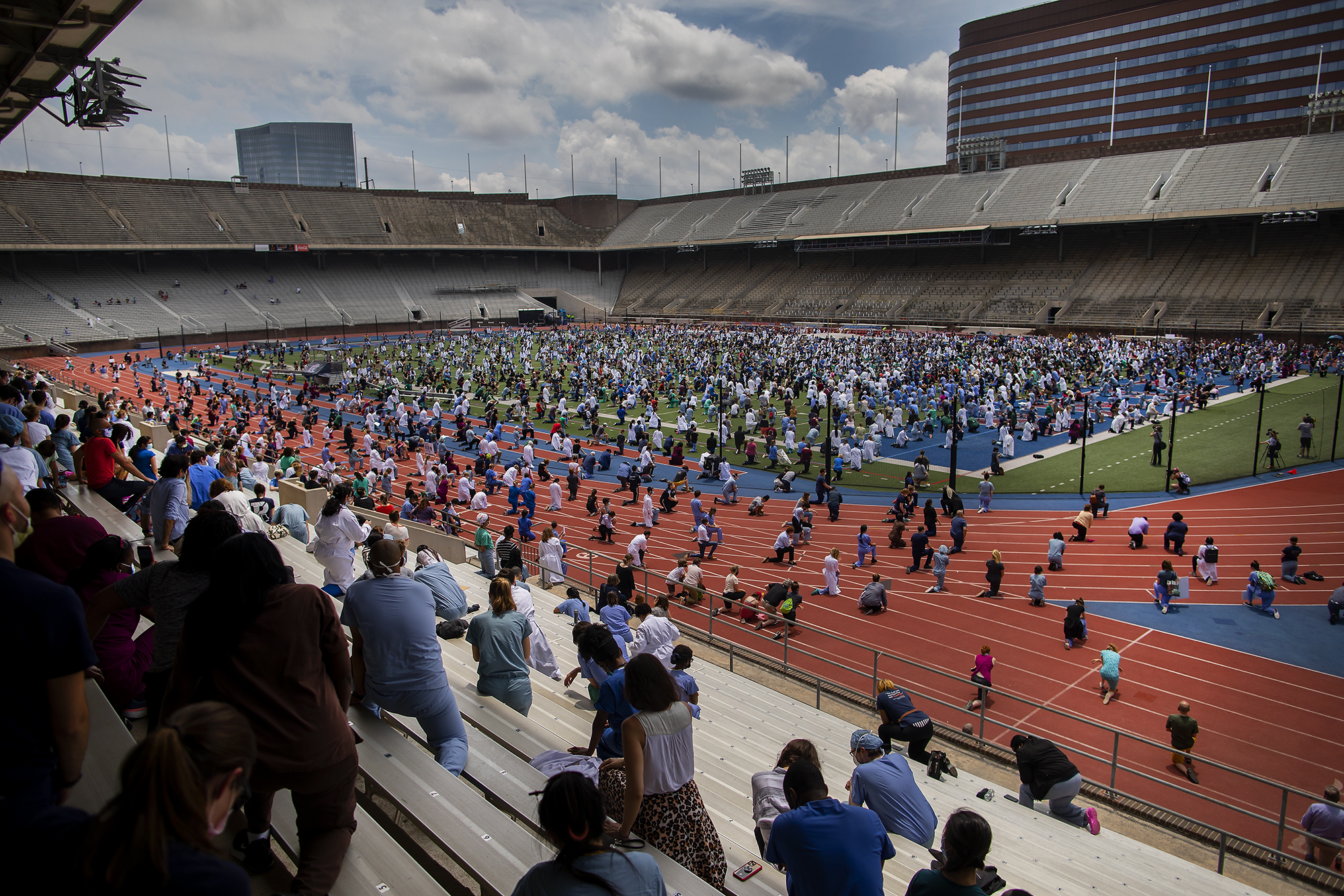 View of Franklin Field from bleachers of Penn Medicine health care workers kneeling in protest.
