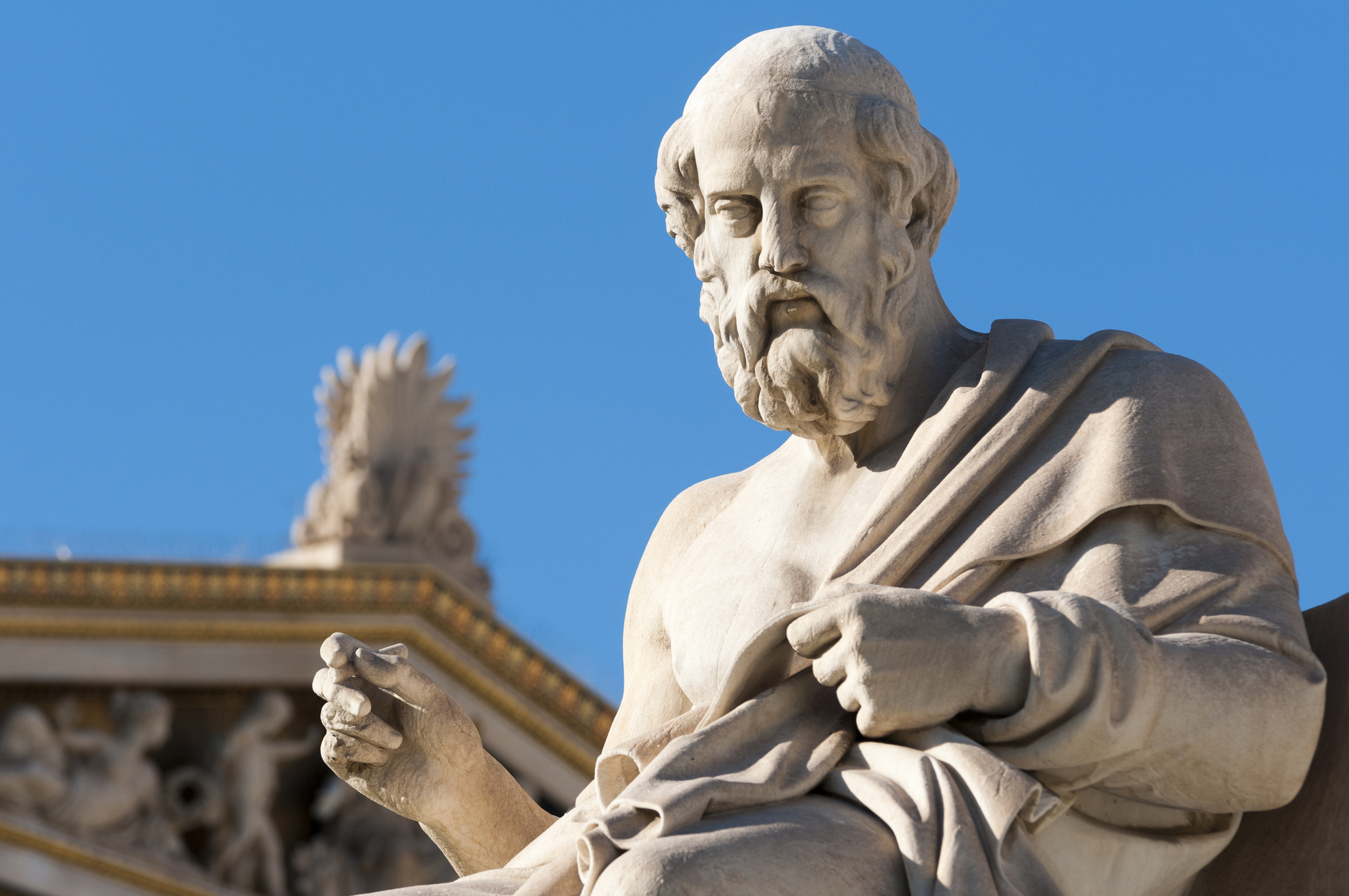 Statue of Plato against blue sky