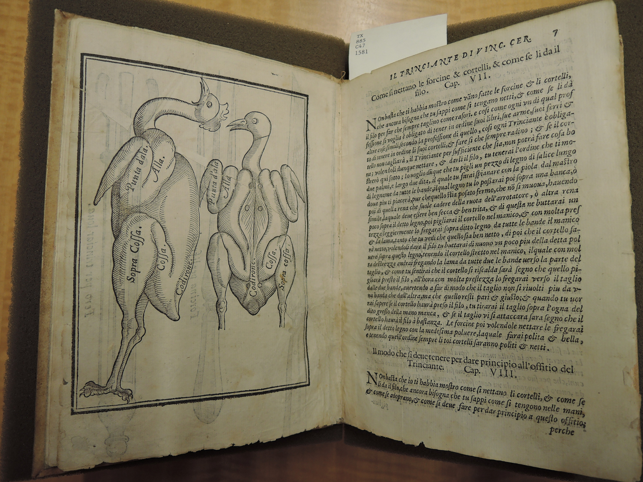 An old book is displays poultry butchering on one side; Italian text on the other