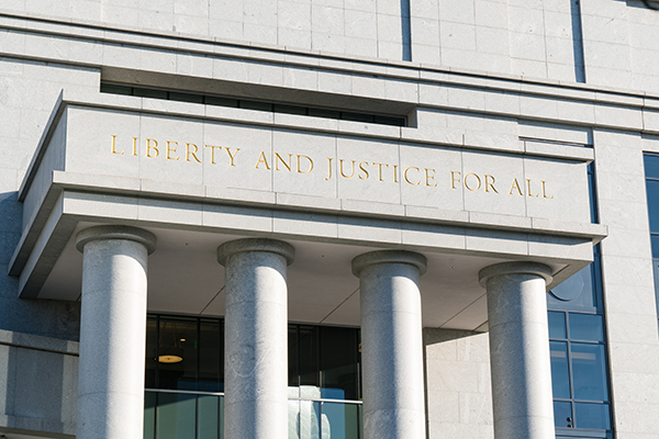 Liberty and Justice for All Sign above the entrance to a Public Defender Office.