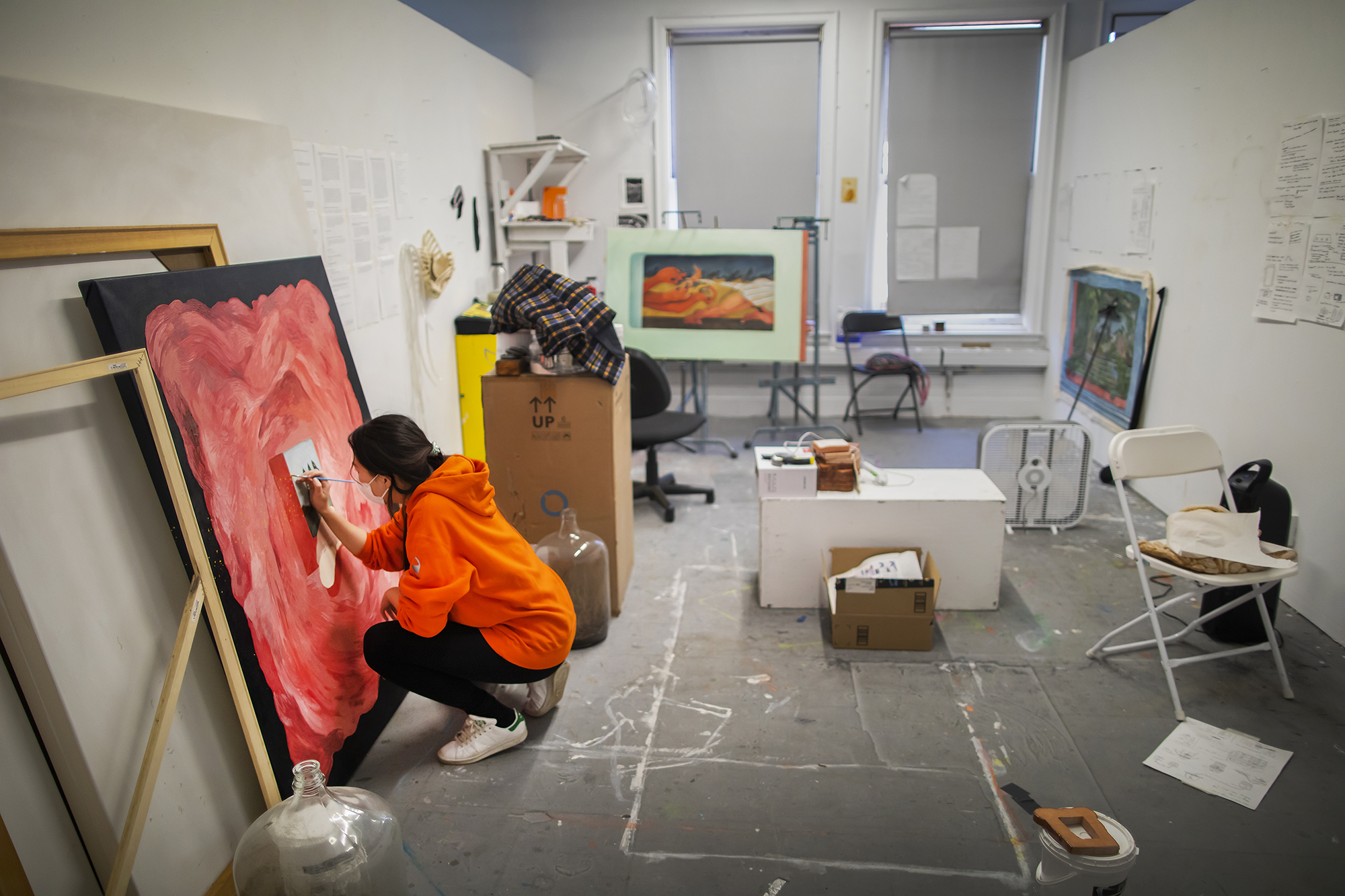 Kay (Seohyung) Lee works on a large canvas on in her studio.