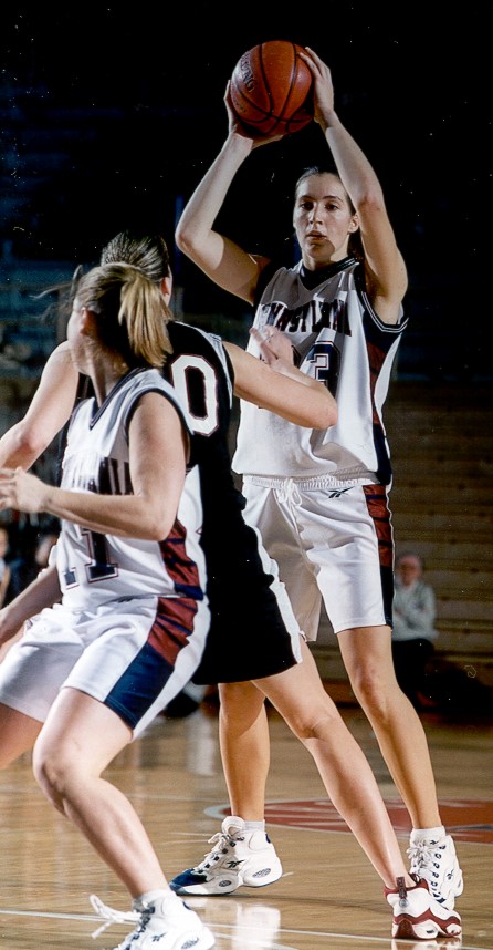 Diana Caramanico holds the ball over her head during a game.