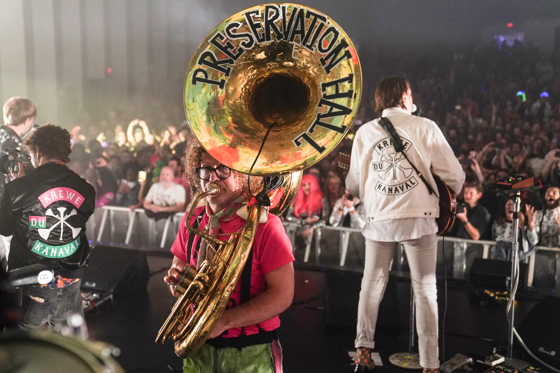 Tuba that reads 'Preservation Hall' with audience in background