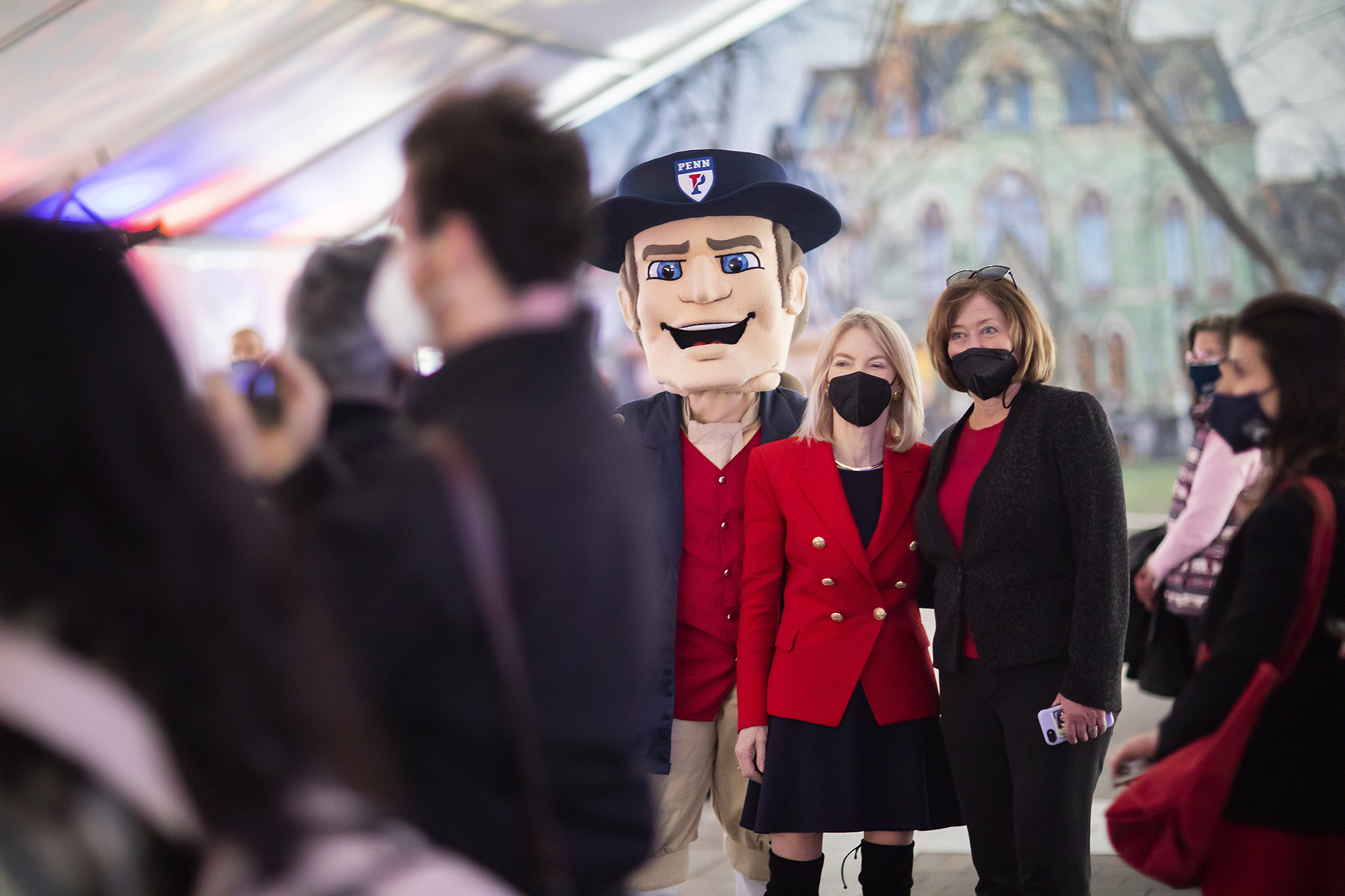 Penn President Amy Gutmann and Penn Quaker mascot and others in a party tent.