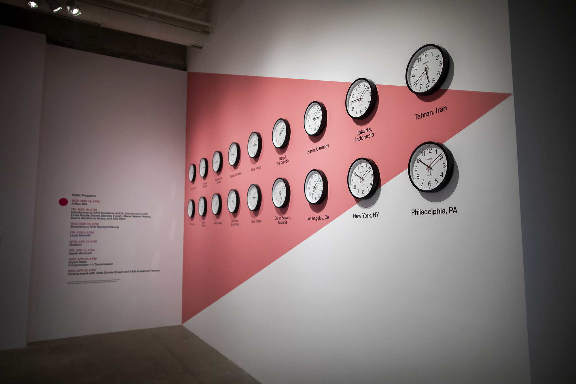 Clocks of the world on a wall with a red triangle