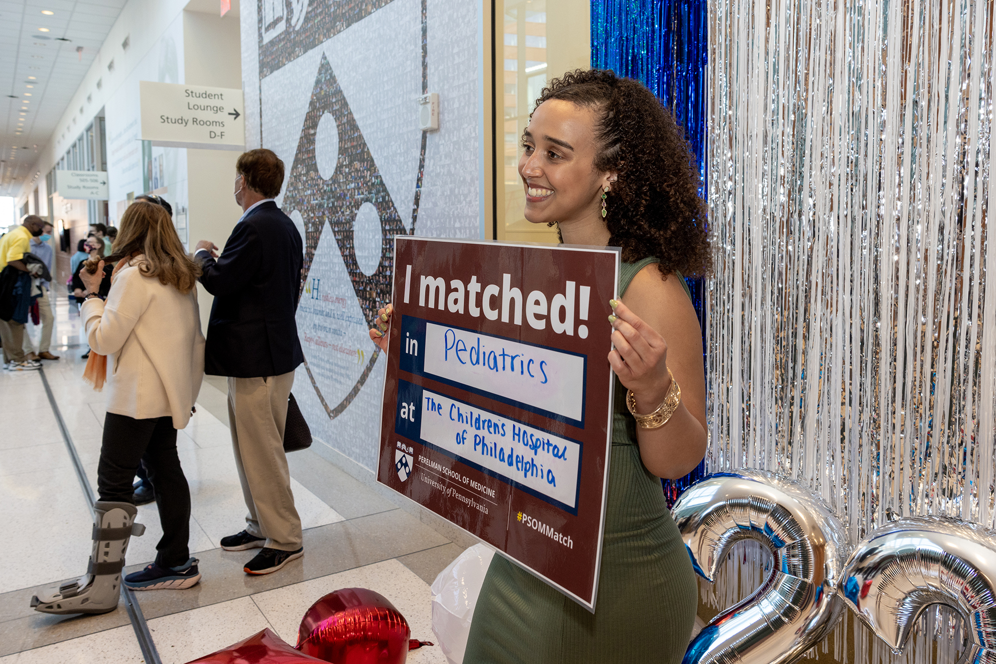 A Penn Med student holds up a large sign that reads I Matched in Pediatrics at the Children’s Hospital of Philadelphia.
