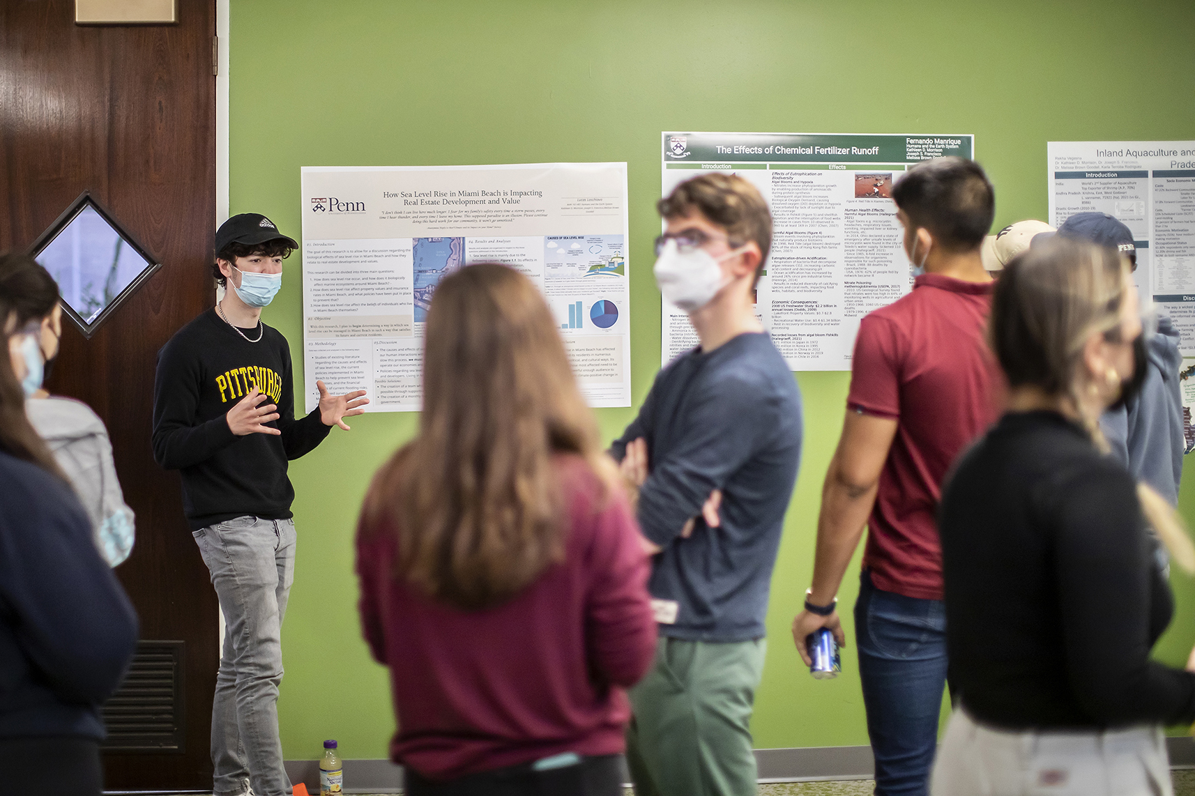 a student presents his poster in a climate change class