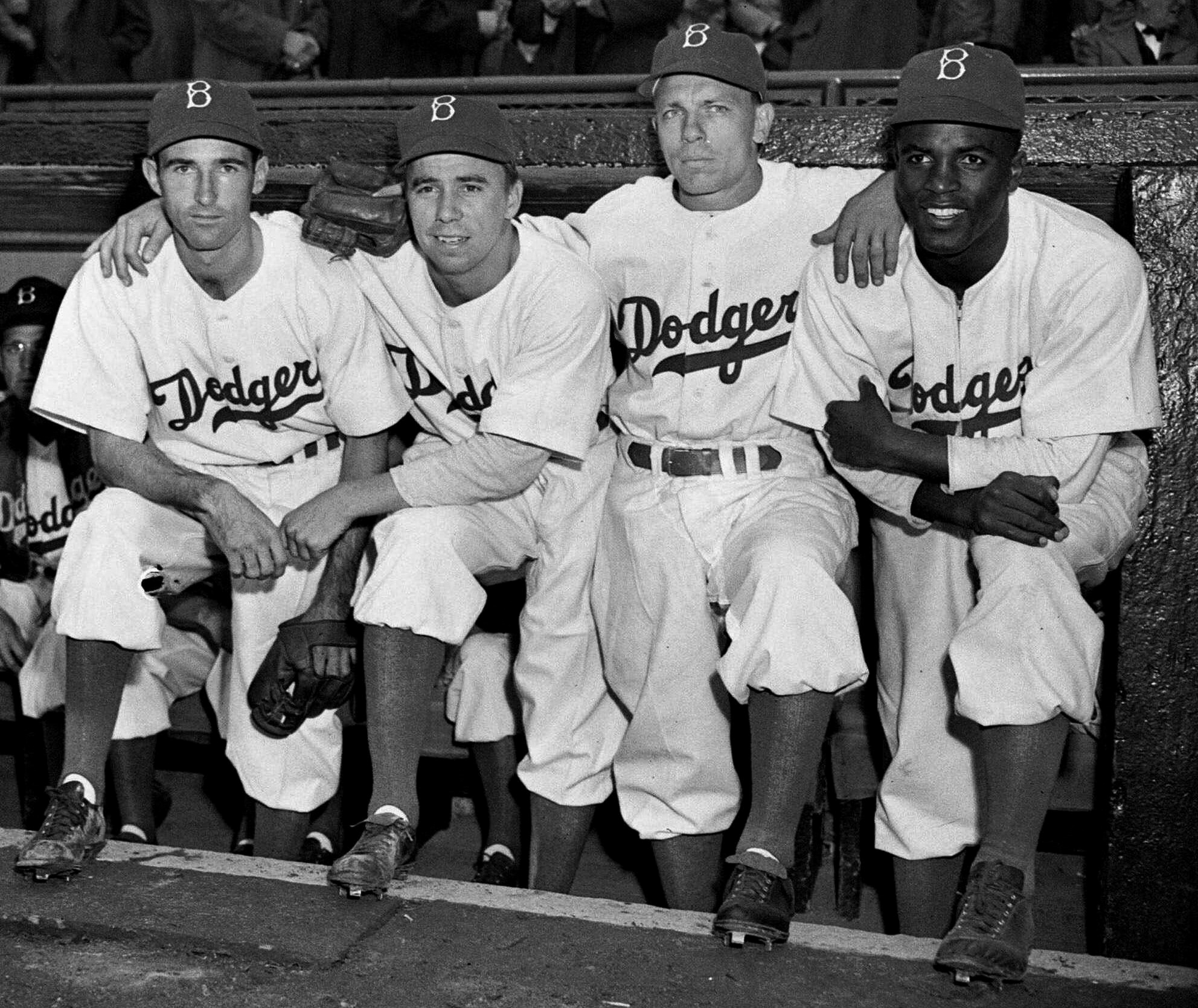 jackie robinson in the dugout with other players