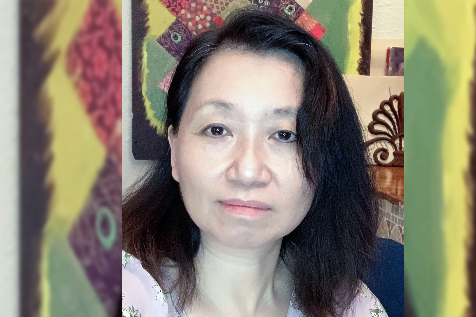 headshot of Lisa Yau with an artwork behind her 