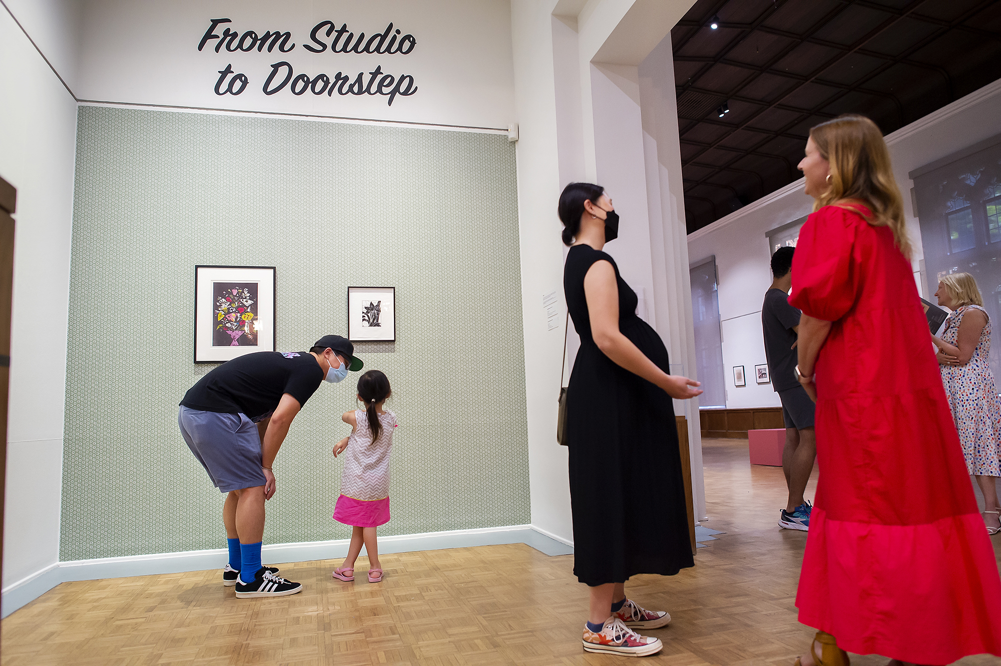 Three adults and a child at the entrance to the Arthur Ross Gallery exhibit, “From Studio to Doorstep.”