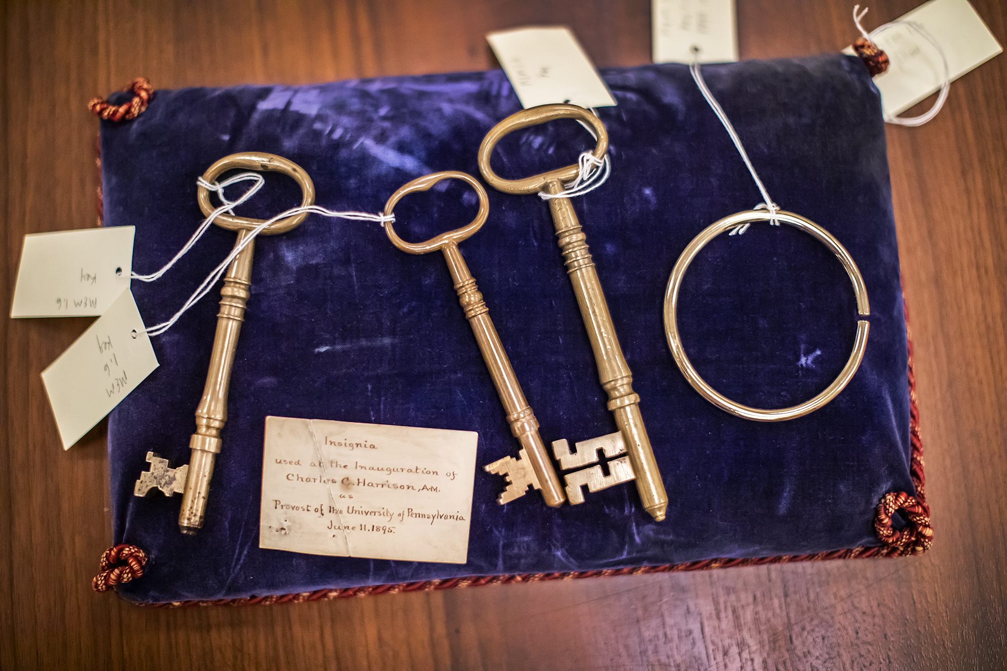Historical keys used in Penn president inaugurations on a velvet bag on a table.