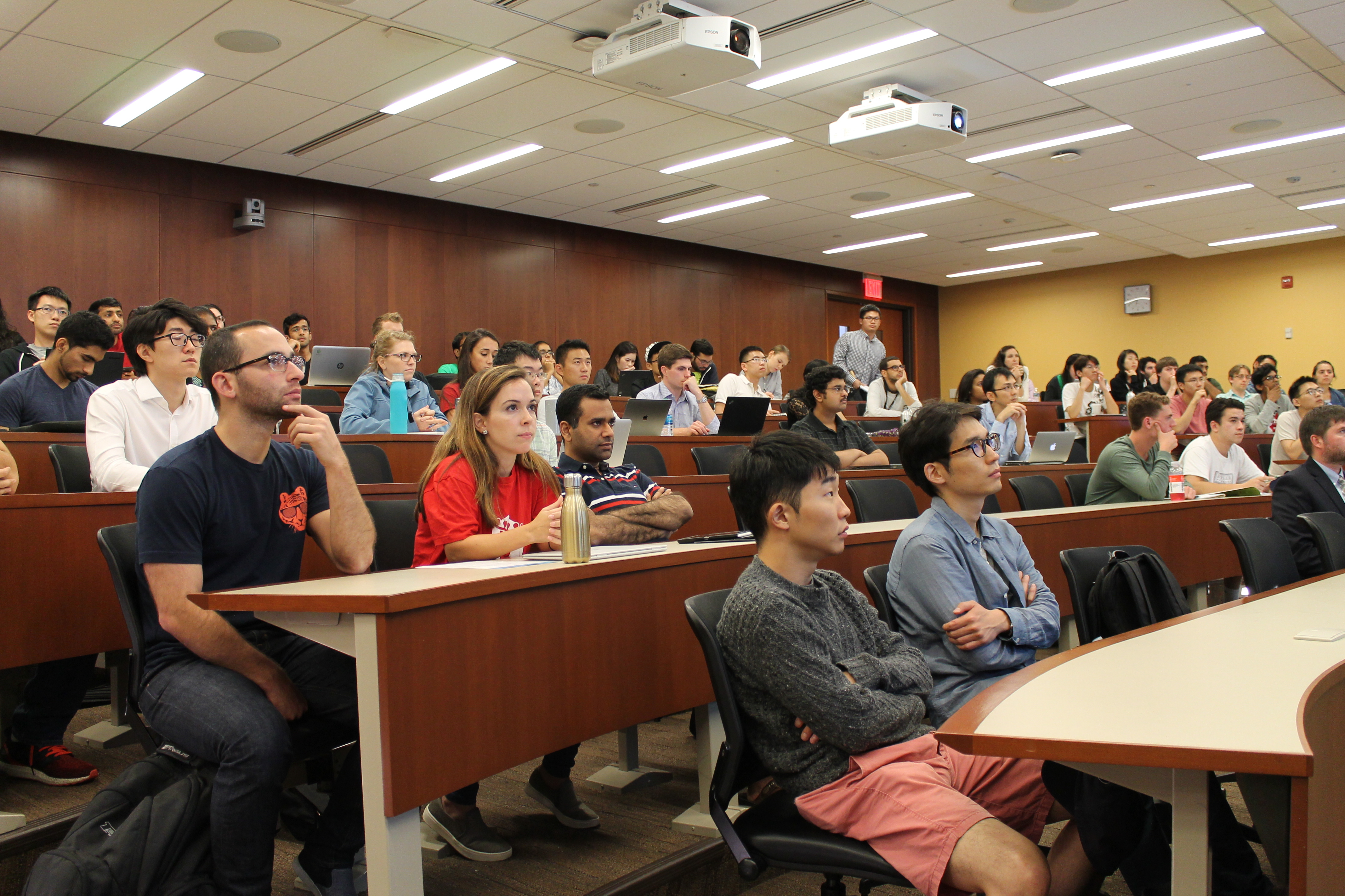 Several rows of students in a lecture room.