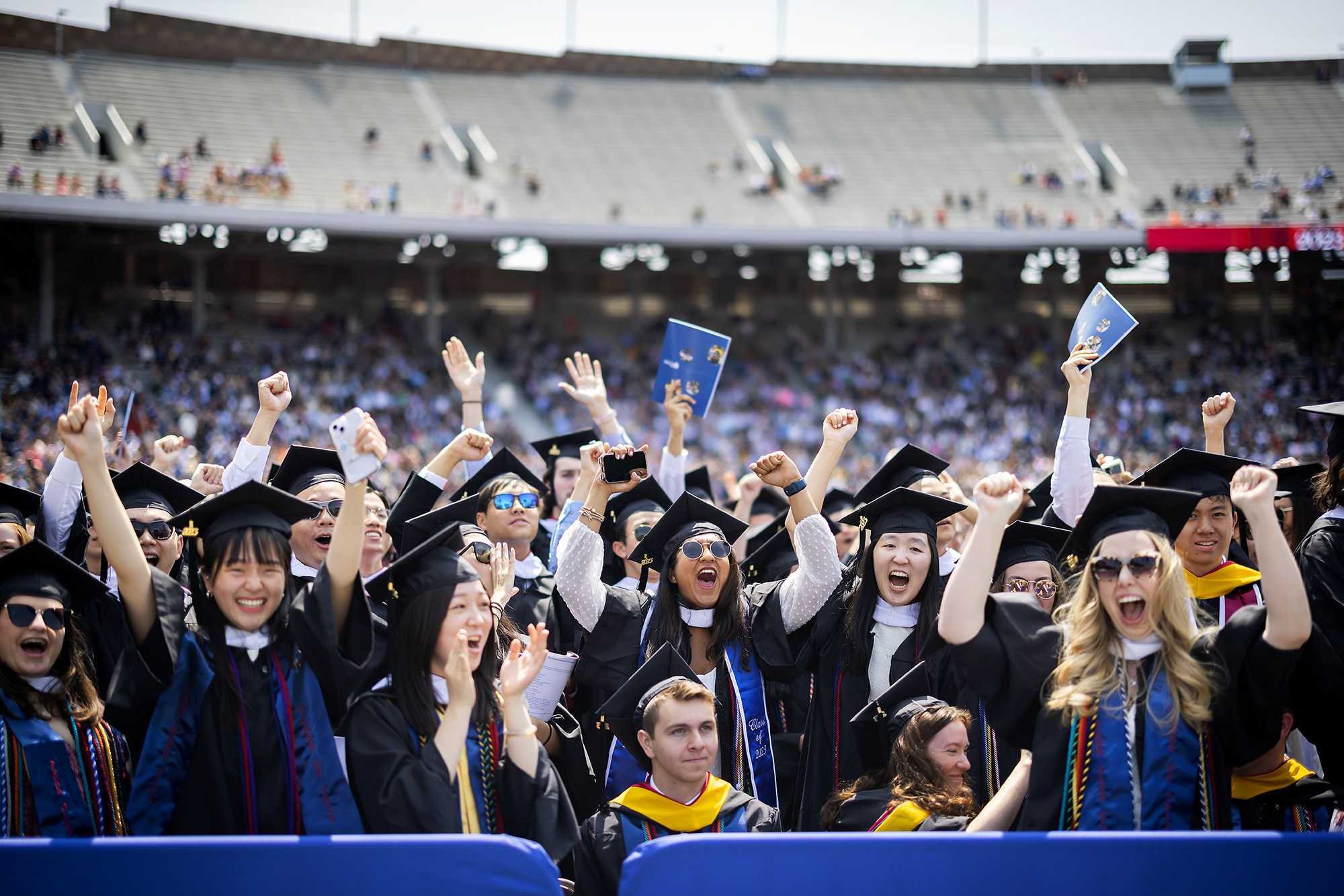 students cheering during commencement