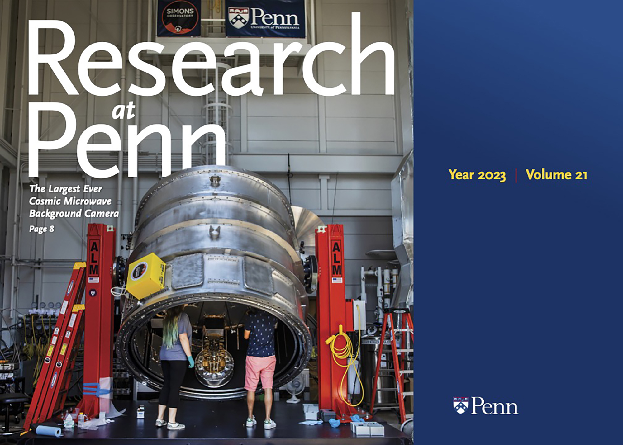 Cover of Research at Penn magazine featuring two people standing near a large piece of metal research equipment.
