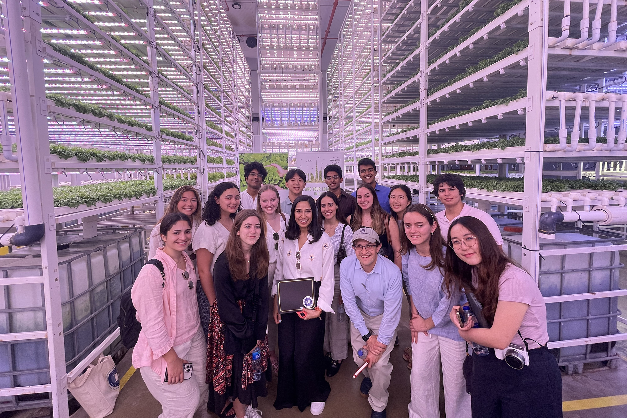 Group of students in a vertical greenhouse.