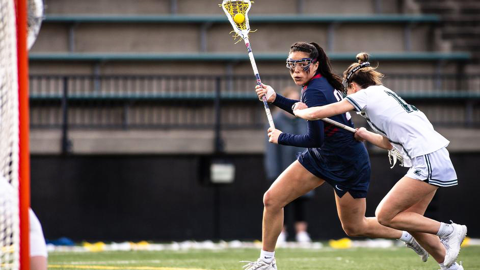 Niki Miles makes a move with the ball in her stick during a game.