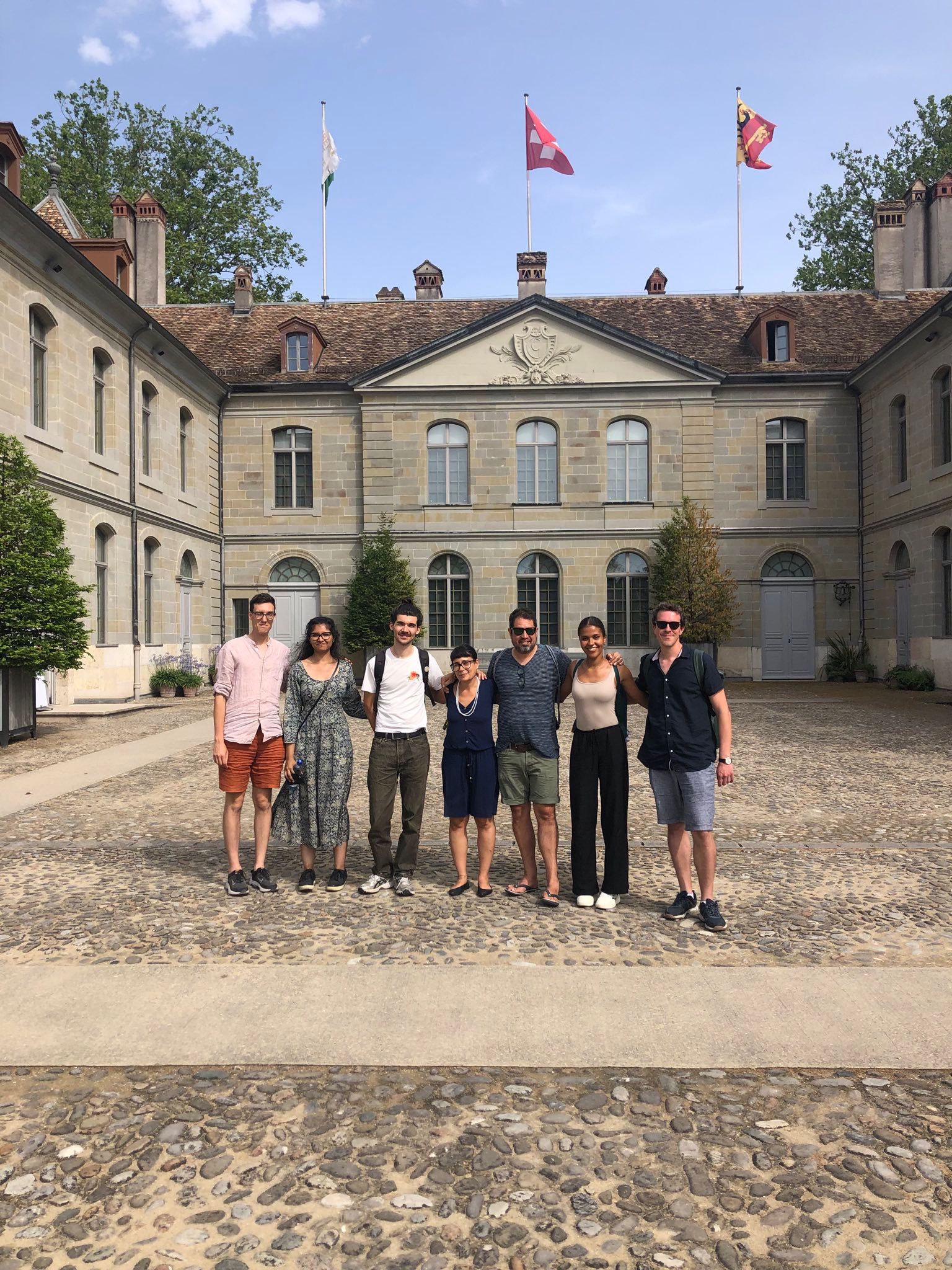 Seven people, including Penn undergrad Sophie Mwaisela, stand in front of the National Museum in Prangins, Switzerland.