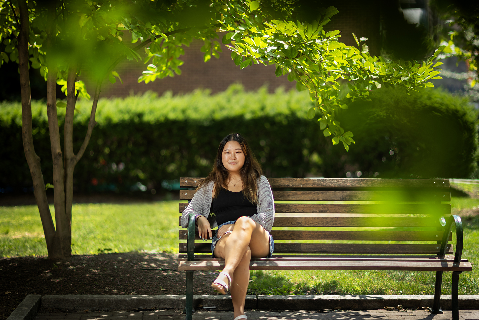 sarah yi sitting on a bench