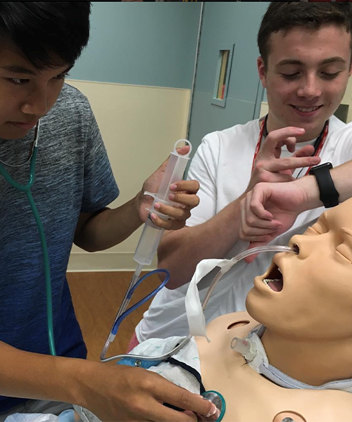 High school students work on intubating a dummy.
