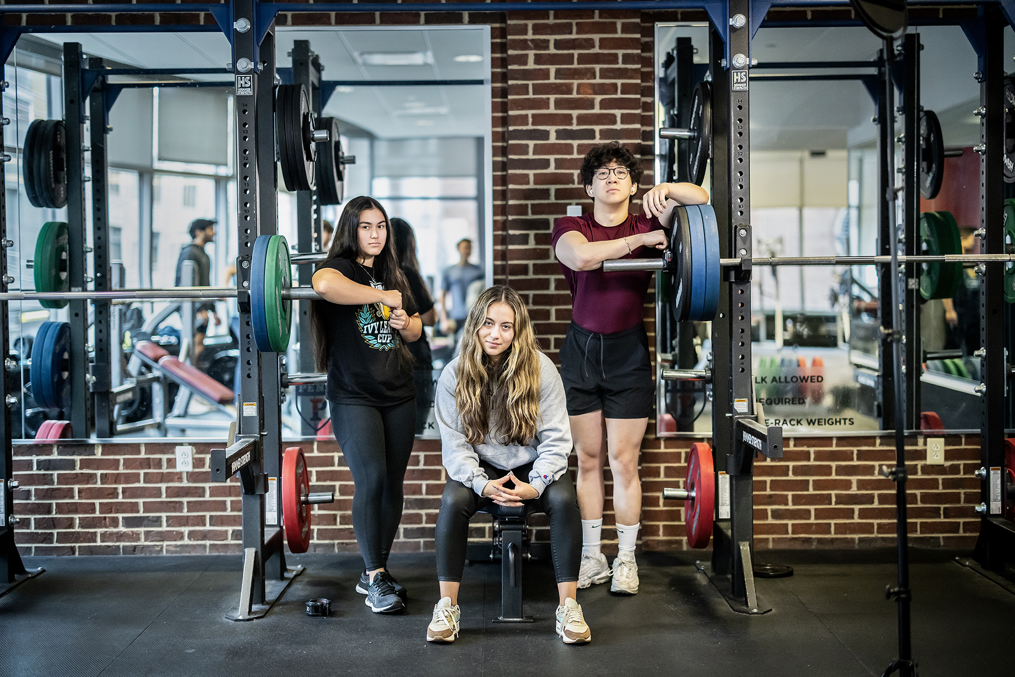 From left, third-year Adrienna Davis, third-year Isabella Pargiolas, and fourth-year Bryan Yan, co-presidents of the Penn Barbell Club, at the Pottruck Health & Fitness Center.