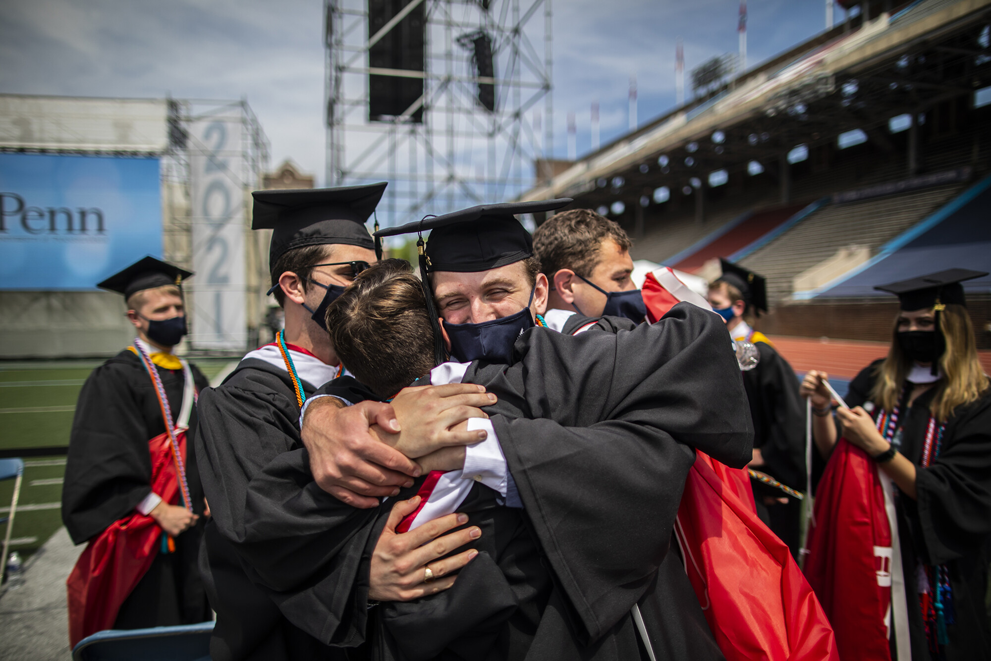 graduates hugging at end of ceremony