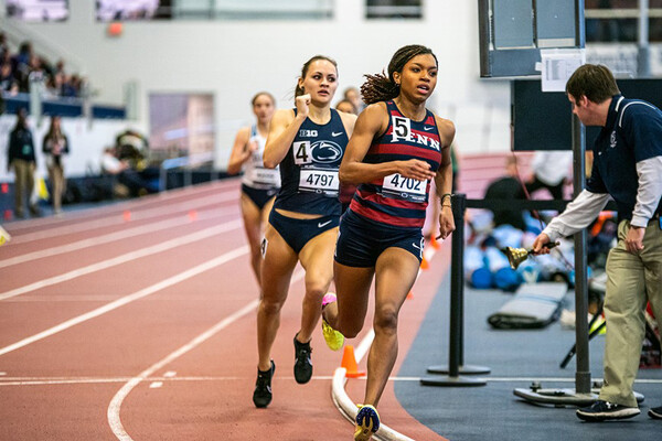 Running at the BU Valentine Invitational, middle-distance runner Nia Akins turns a corner while racing in the 800m.