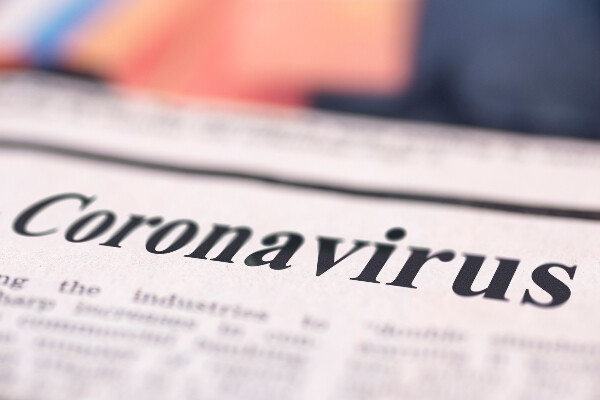 a close up of a newspaper with coronavirus written on top