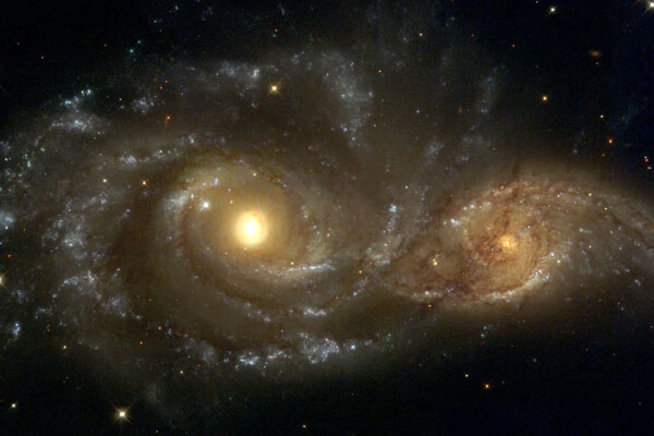 two spiral galaxies merging together