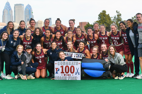 After a home win over Columbia at Ellen Vagelos Field, the field hockey team poses with a banner celebrating Head Coach Collen Fink's 100th win.