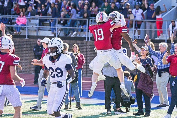 During the Homecoming game against Yale at Franklin Field, two Penn players jump into each other's arms in celebration.