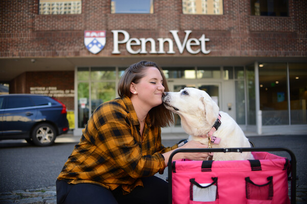 Meg Ruller with her dog Maple in front of Penn Vet