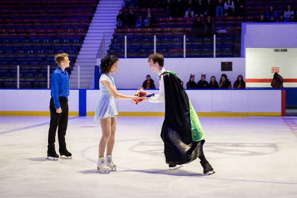 In an opening scene of The Nutcracker performed by the Penn Figure Skating club, attending a party Christmas Eve, Drosselmeyer (Eric Sigg), gives the nutcracker to Clara (Fay Shuai) with her brother Fritz (Nick Bausenwein) standing by.